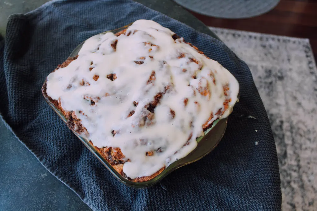 Finished vegan cinnamon roll cake with cream cheese frosting on top